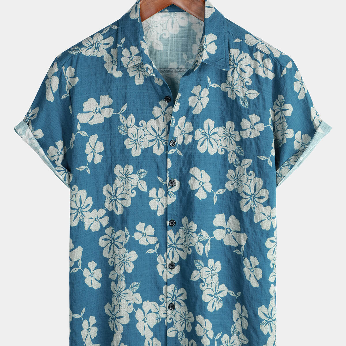 Camisa hawaiana de manga corta con botones y estampado floral festivo en color azul para hombre