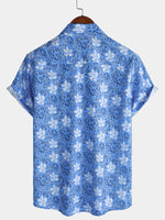 Camisa playera de algodón con estampado floral tropical de manga corta para hombre